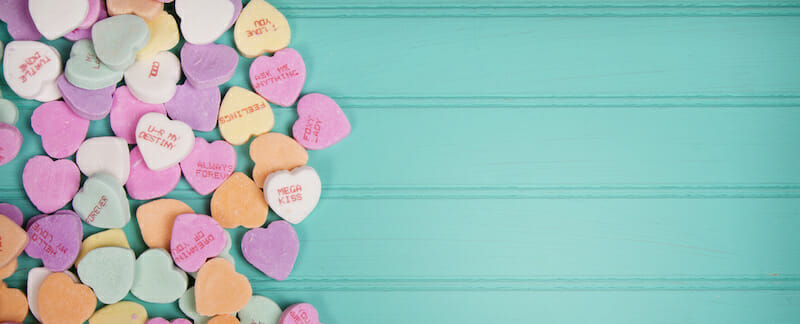 Candy conversation heartson a turquoise blue background